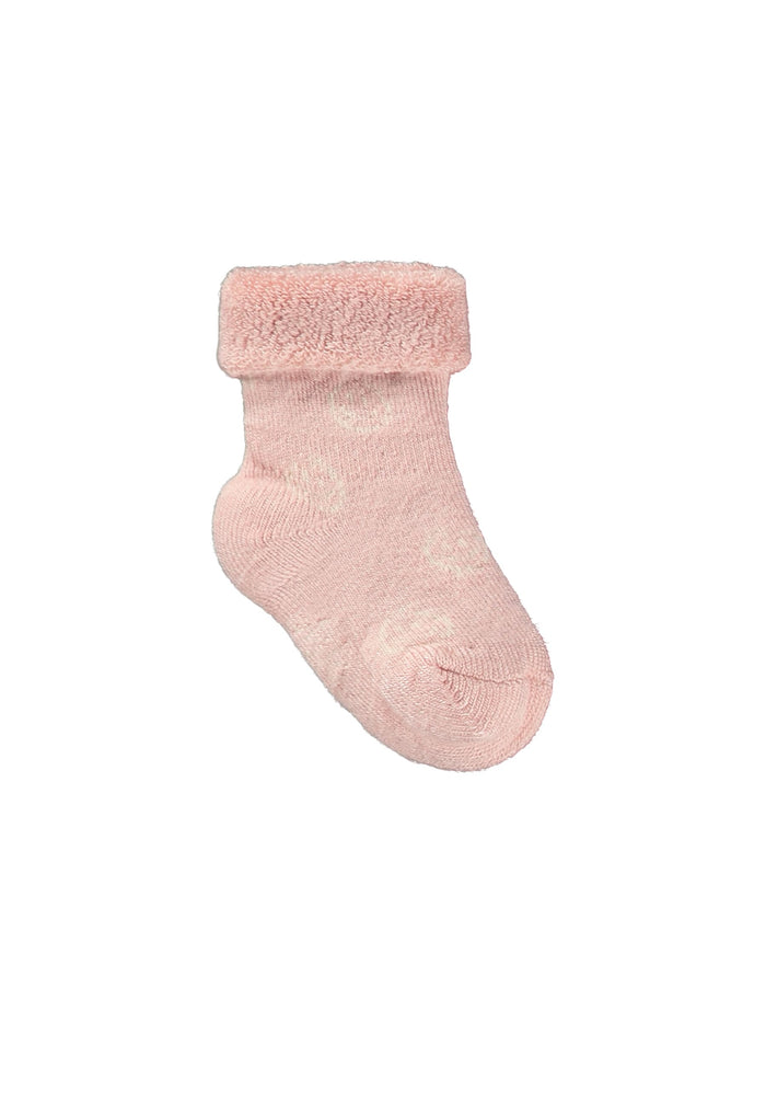 Pink baby sock with fuzzy texture on a white background
