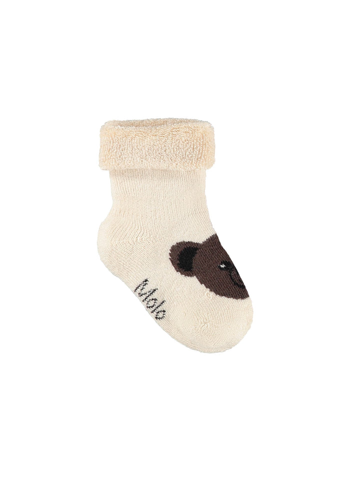 Beige baby sock with brown bear design and 'Molo' branding on a white background