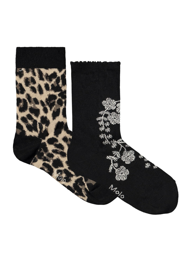 Two socks with leopard print and floral design on a white background