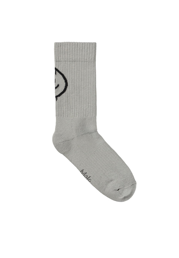 Gray sock with a black smiley face design on a white background