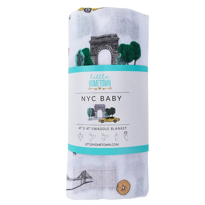 Swaddle blanket with 'NYC Baby' design and 'little hometown' branding on a white background