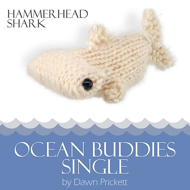 Ocean Buddies Single pattern cover for Hammerhead Shark showing a cream knitted hammerhead shark toy with wave border and title by Dawn Prickett