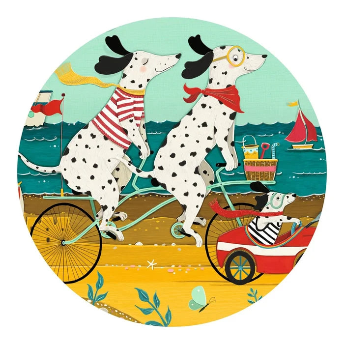 Illustration of two Dalmatians riding a tandem bicycle on a beach with a sailboat in the background.