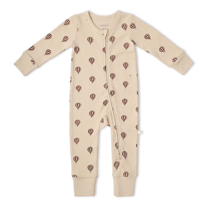 zip down baby one-piece in beige with red stripe hot air balloon print on white background