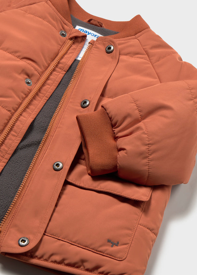 Brown puffer jacket with a visible brand label on a white background