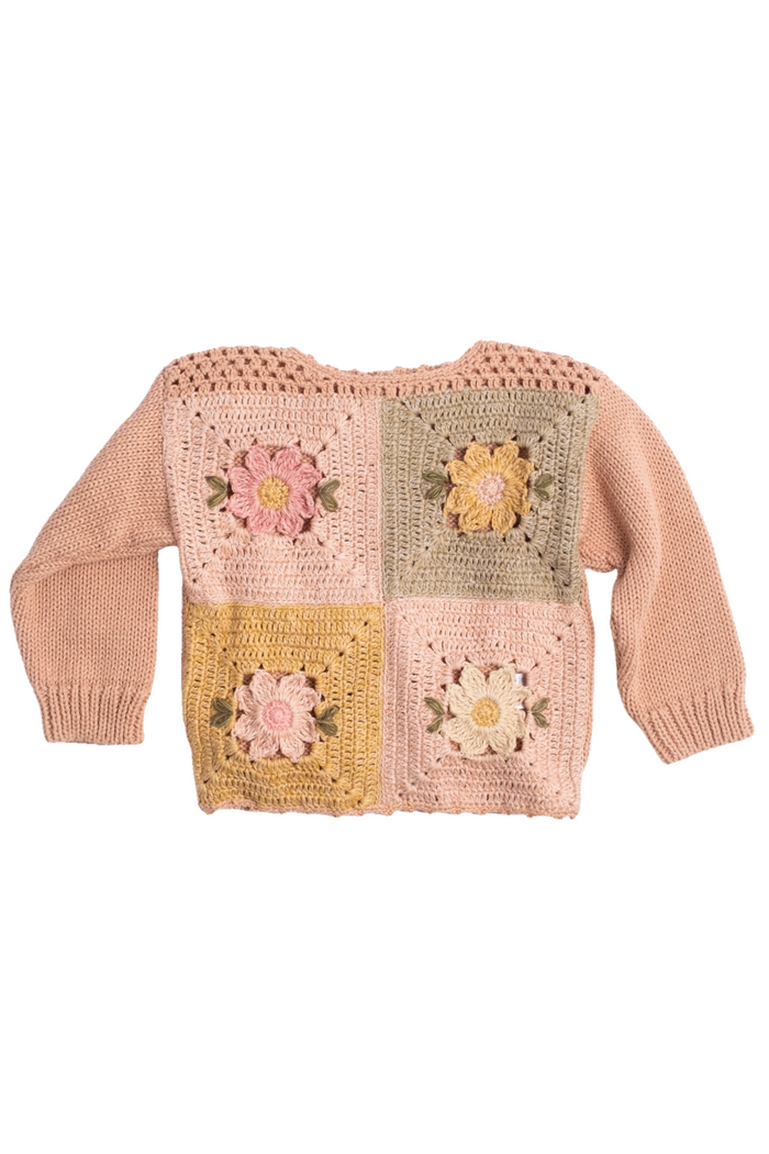 A pink knit sweater with four colorful crocheted granny square panels on the front, displayed against a plain white background.