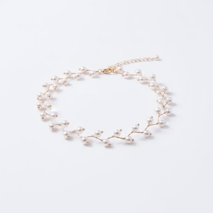 A delicate 18k gold-dipped choker featuring a branch-inspired silhouette adorned with small, radiant pearls, designed with a tarnish-resistant titanium steel base for a modern, high-end editorial aesthetic.