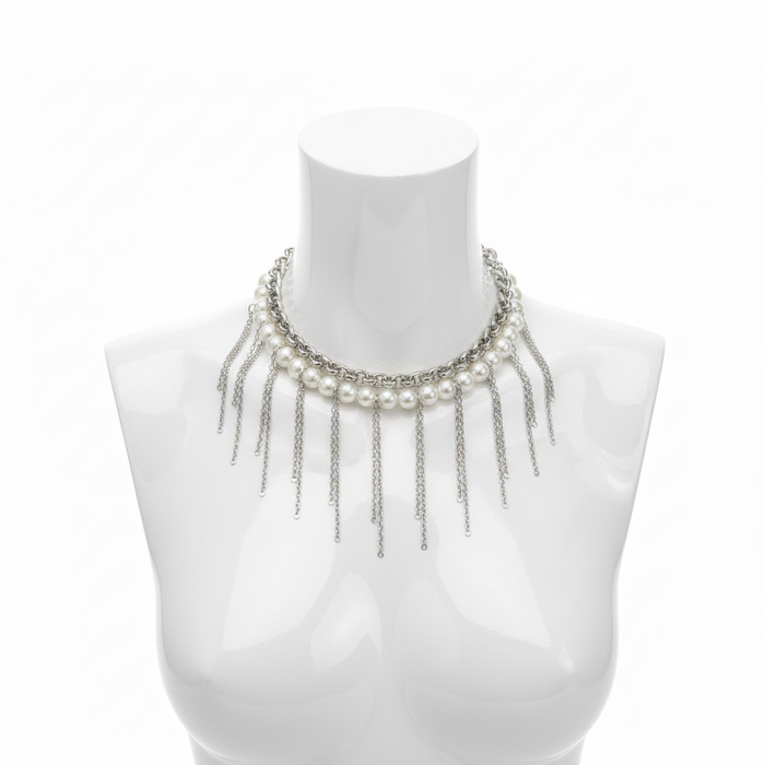 A striking statement choker featuring a row of luminous white pearls paired with a rugged silver-toned industrial chain and dramatic cascading fringe drops for a modern, high-fashion editorial aesthetic.