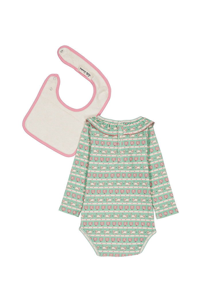 A baby clothing set featuring a long-sleeve bodysuit with a green, pink, and white patterned design, and a matching bib with a pink border and cream center, laid flat on a white background.