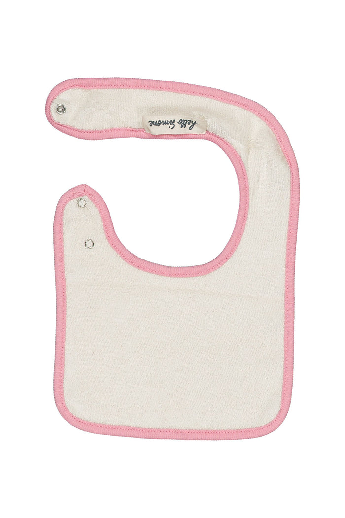 An off-white cotton baby bib with pink trim and snap closures, featuring a small embroidered brand label that reads 'Hello Simone'.