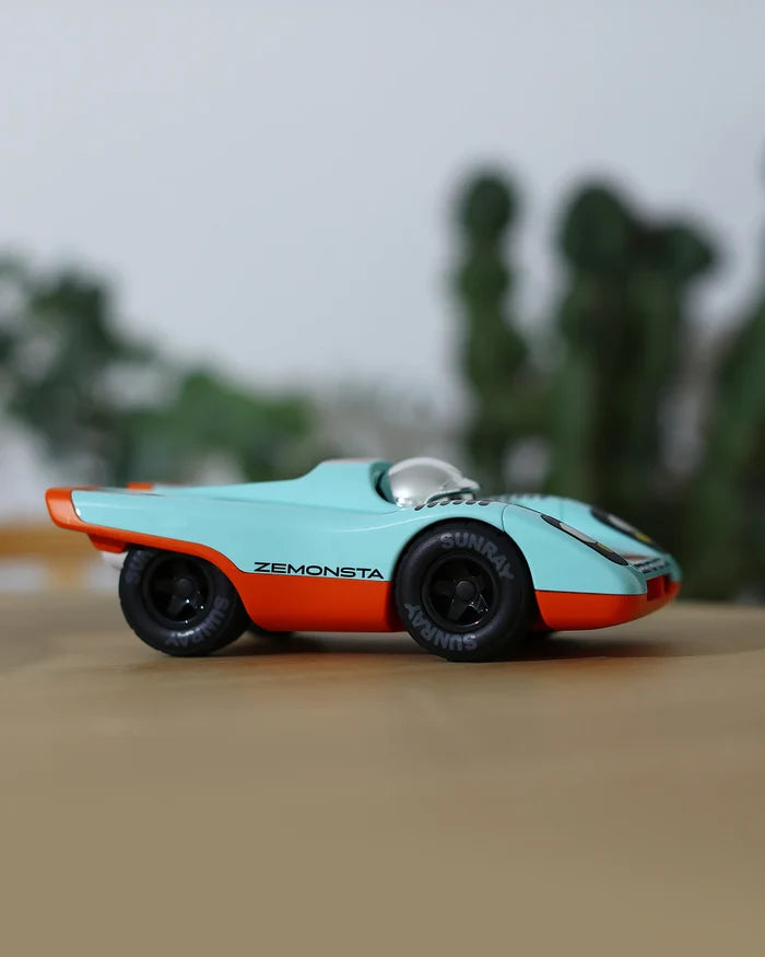 Model car with 'Zemonsta' branding on a blurred natural background