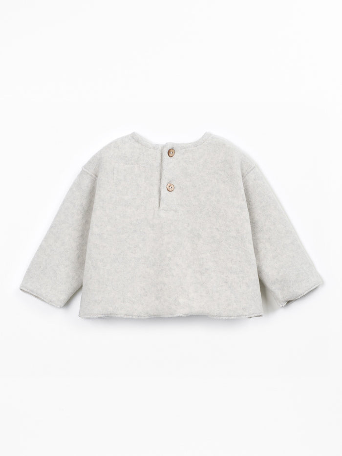 A light gray heathered knit long-sleeve top for toddlers, featuring a henley-style neckline with two small brown buttons, shown flat on a white background.