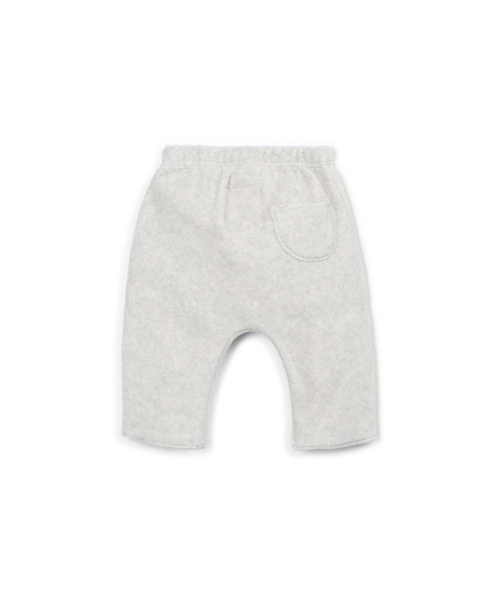 Light gray heathered knit pants for toddlers, featuring an elastic waistband, a side patch pocket, and a curved leg design, shown against a plain white background.