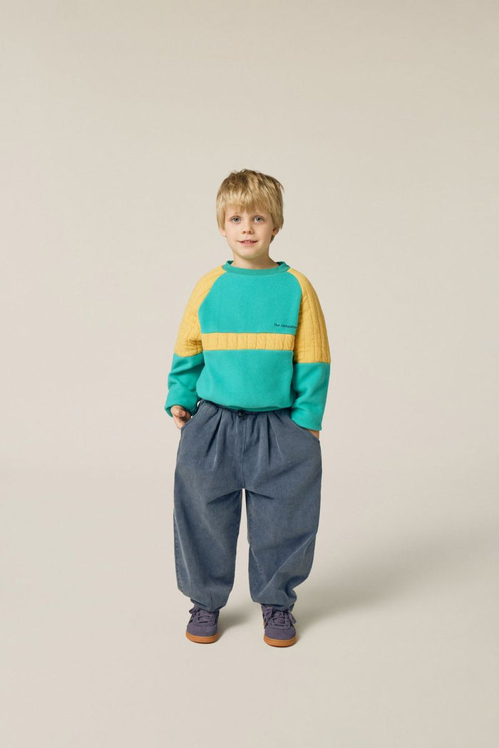 Child wearing green polar sweatshirt