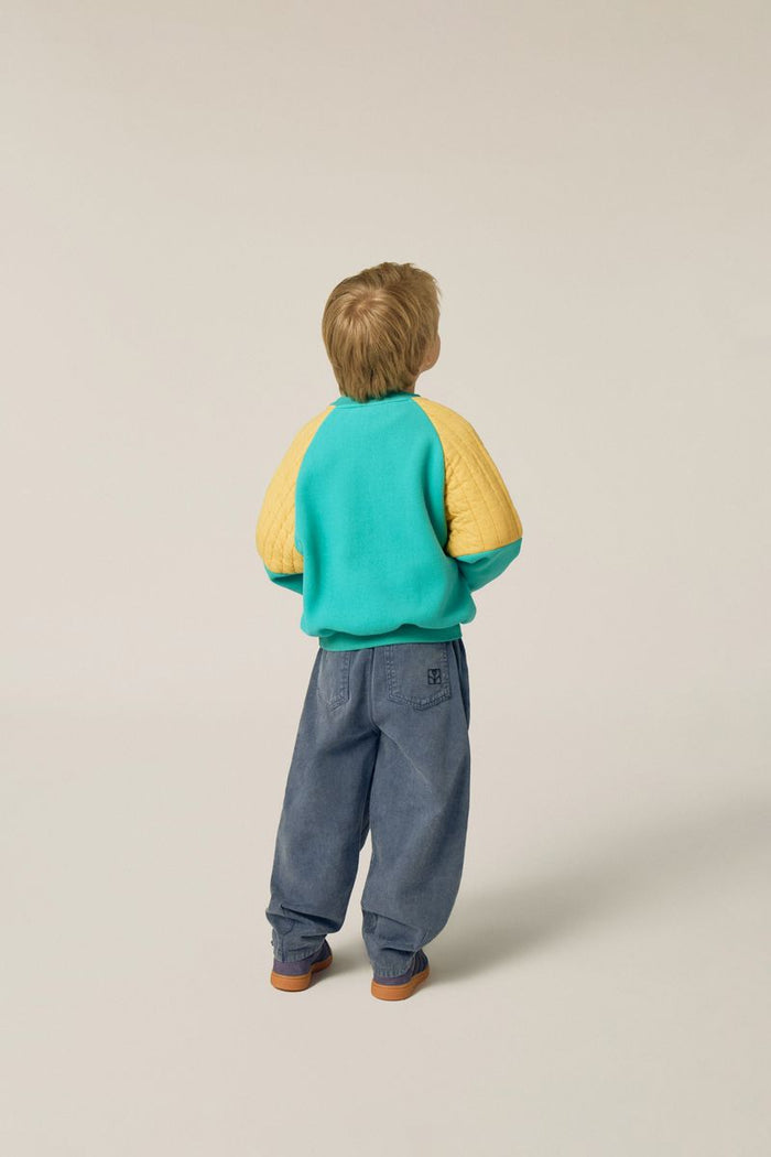 Child wearing green polar sweatshirt
