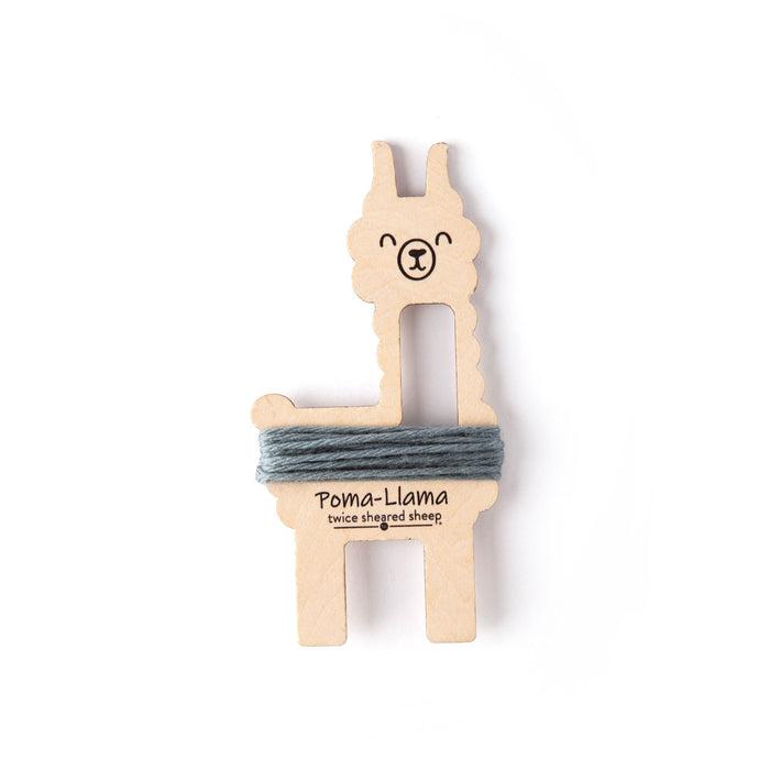 Poma-Llama tool with grey-blue Dove yarn wrapped around its lower body showing pom pom wrapping position on a white background