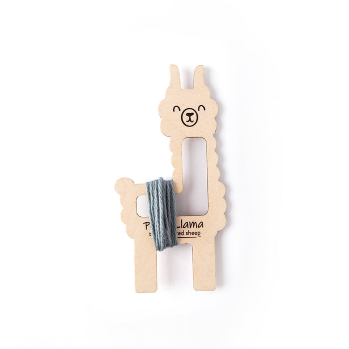 Poma-Llama tool with grey-blue Dove yarn wrapped vertically around its neck and body showing lucet cord wrapping position on a white background