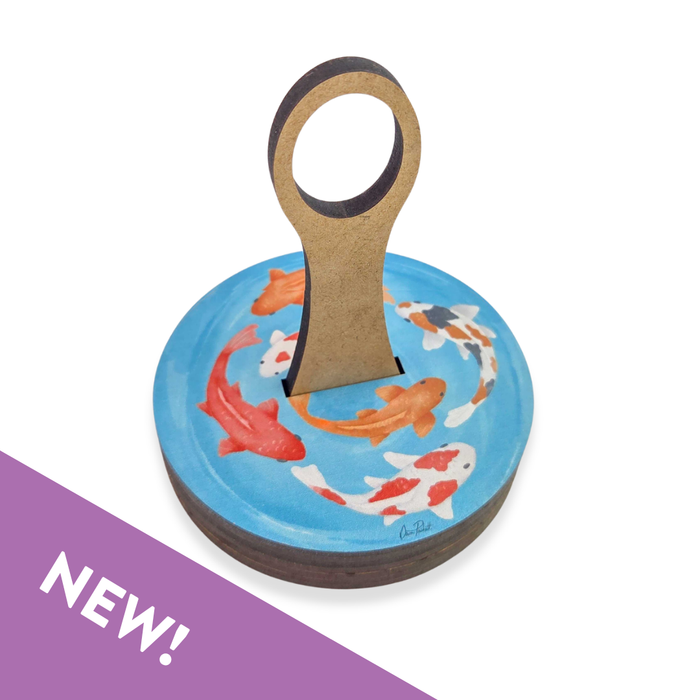 Decorative magnet with koi fish design on a blue background, featuring a handle.