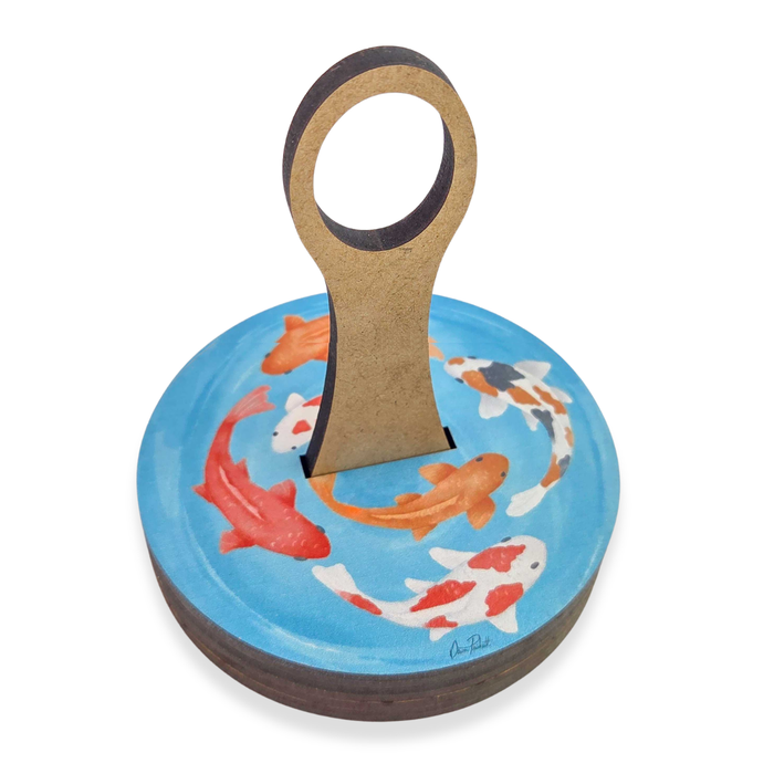 Koi Fish Yarn To Go Carousel holding a skein of yarn on its spindle, showing the koi pond artwork on the wooden top