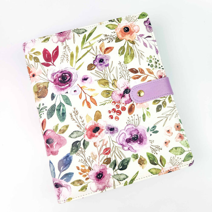 Spring Floral Project Journal Planner front cover with watercolor pink, purple, and coral roses and green foliage pattern on cream faux leather with lavender snap closure