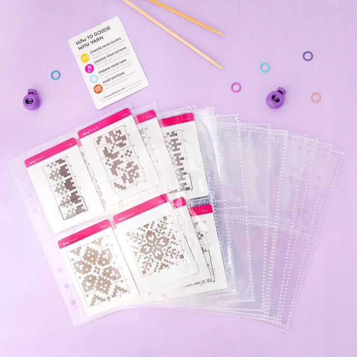 Card protector sleeves with colorwork knitting chart cards and How to Doodle with Yarn instruction card displayed on a lavender background with knitting needles and stitch markers