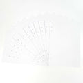 Fan of 24 white dot grid refill pages with hole-punched binding edge