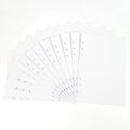 Fan of 24 white graph paper refill pages with hole-punched binding edge