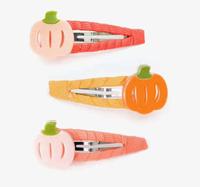 A set of three hair snap clips with pumpkin designs in orange and pink, made of acrylic.