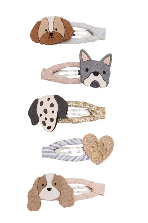 A set of five dog-themed hair clips on a plain white background, featuring different dog breeds and textures like glitter, stripes, and plush fabric.