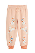 Pink sweatpants with cartoon bunny design on a white background