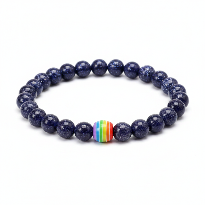 Deep blue shimmering sandstone bead bracelet with a central rainbow striped focal bead on a clean white background.