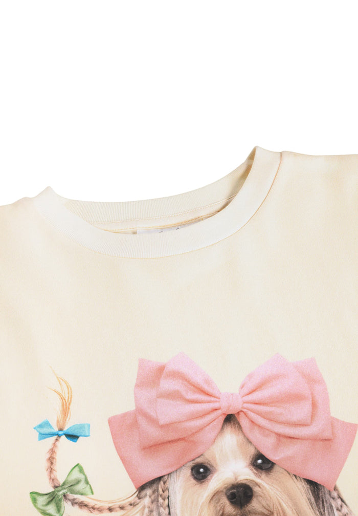 Shirt with a dog wearing a large pink bow on a white background