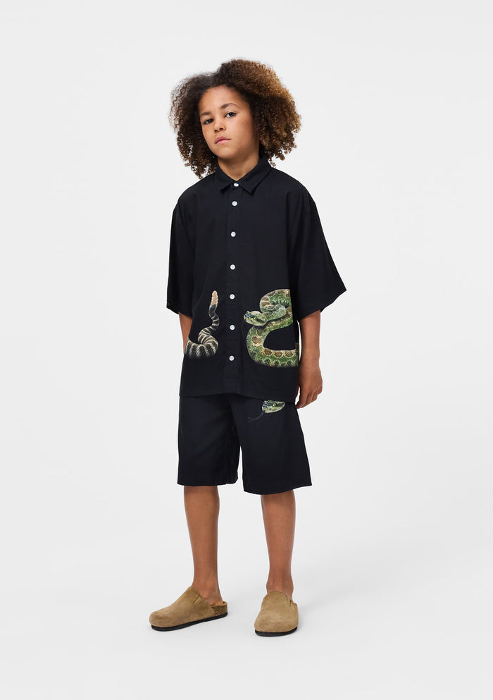 Person wearing a black shirt with snake design