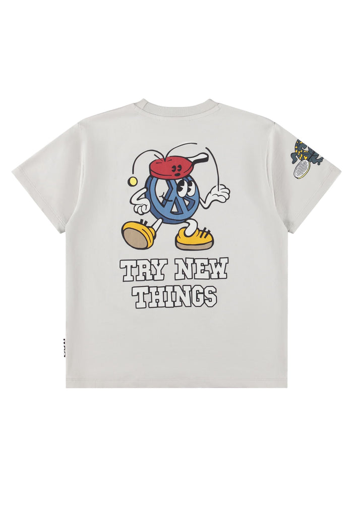 White t-shirt with cartoon character and 'Try New Things' text on a white background