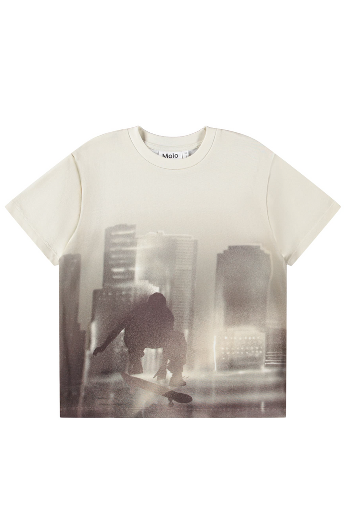 White t-shirt with a printed design of a person in a cityscape on a white background