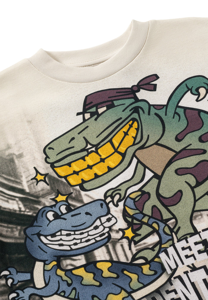 Beige t-shirt with a colorful graphic of a dinosaurs on a white background