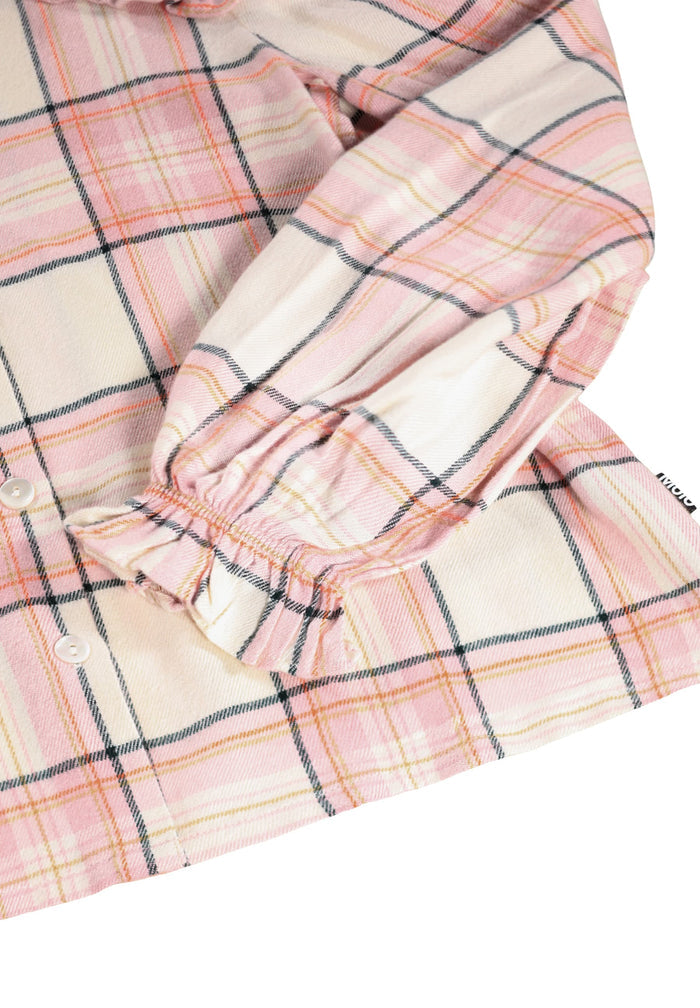 Close-up of pink and beige plaid fabric with a white background