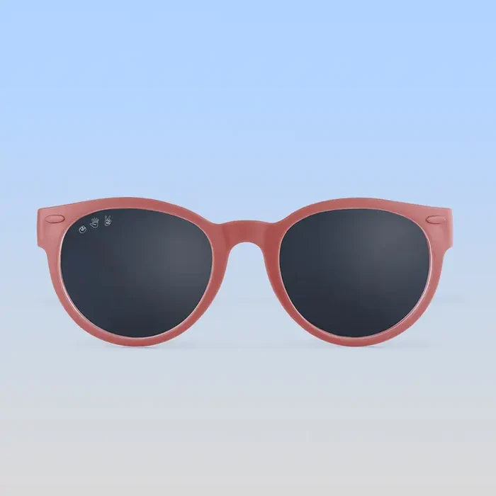 Pink sunglasses with dark lenses on a white background