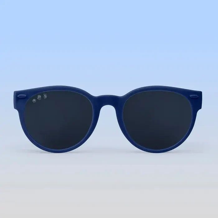 Blue sunglasses with dark lenses on a light blue background