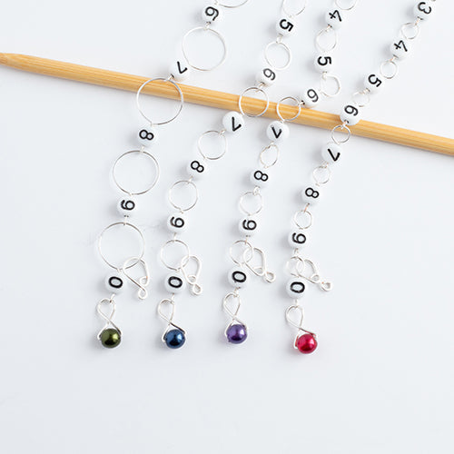 Fairy Lights row counter starter set with four numbered bead chain counters featuring green, blue, purple, and red pearl charms