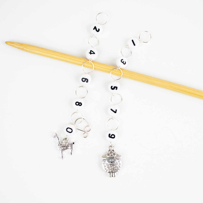 Two straight chain row counters on bamboo needle with silver llama charm for even numbers and silver sheep charm for odd numbers