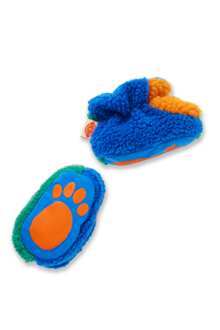 Blue and orange baby booties on a white background