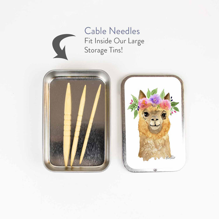Three shortie bamboo cable needles stored inside an open Flower Alpaca storage tin, showing how they fit in the large slide-style tin