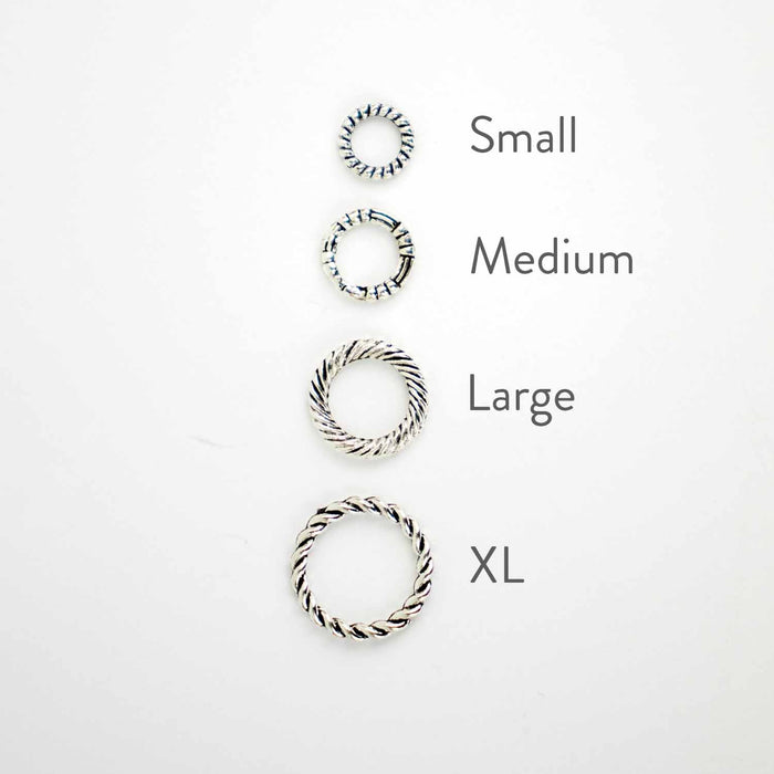 Simple Braided Ring stitch markers sizing guide showing Small Medium Large and XL sizes on needles