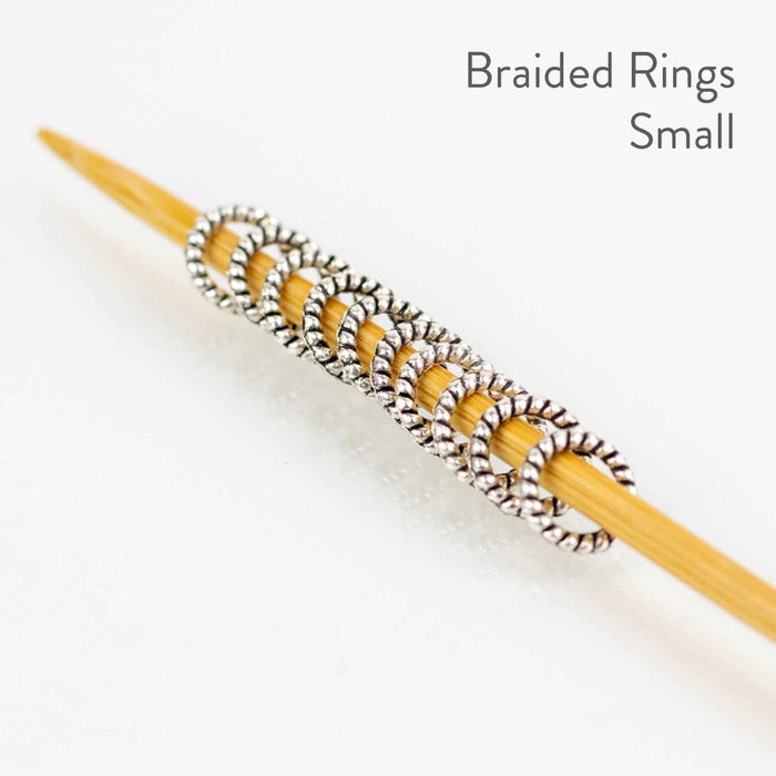 Close-up of small Simple Braided Ring stitch markers showing smallest size option