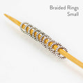 Close-up of small Simple Braided Ring stitch markers showing smallest size option