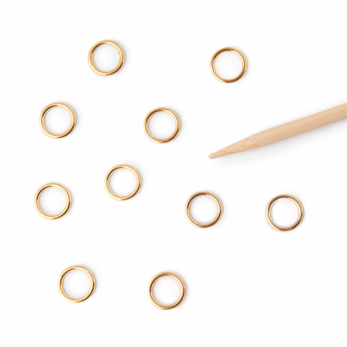 Simple Gold Ring stitch markers on bamboo knitting needles with colorful project showing markers in use