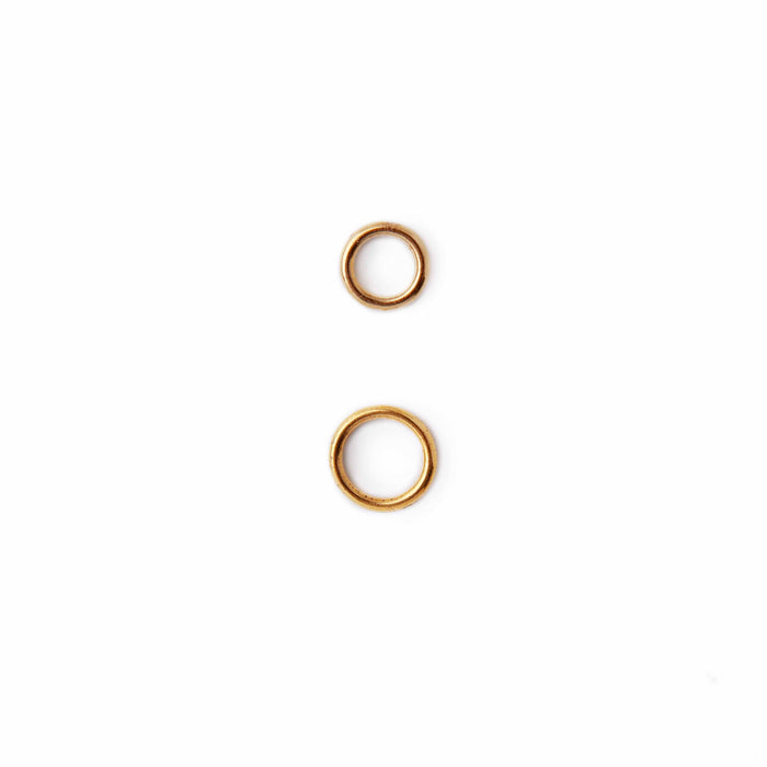 Two simple gold ring stitch markers shown at actual size on white background, one small and one medium