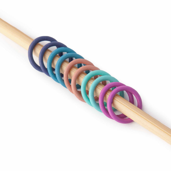 Simple Ring stitch markers in rainbow anodized colors large size on knitting needles with colorful project