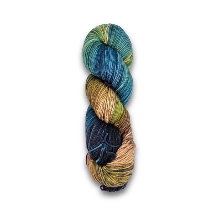 Yarnaceous Fibers Smuggler's Bay sock yarn skein shown twisted, dark teal, navy, olive and sandy tan